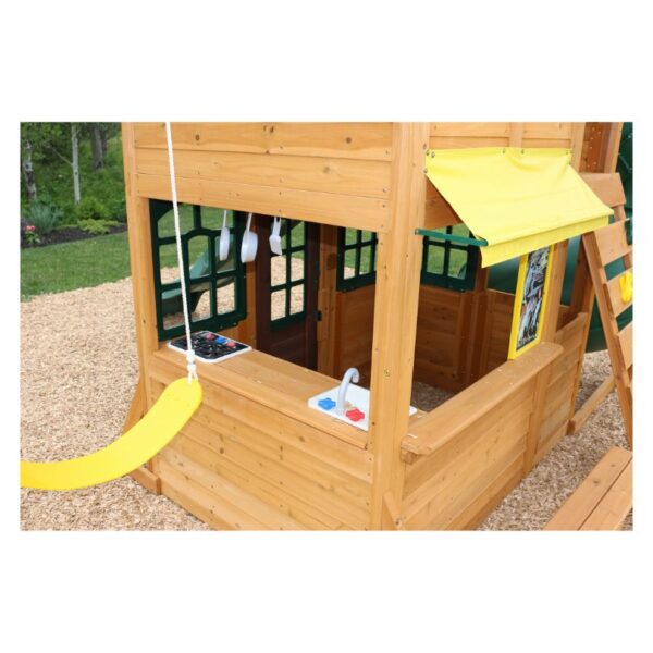 A wooden play fort with multiple levels, slides, and climbing features, designed for children's outdoor play and adventure