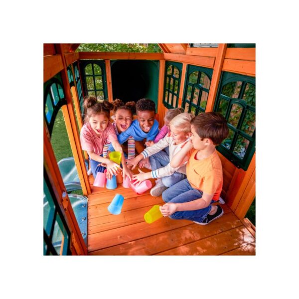 KidKraft Falcon Ridge Swing Set featuring swings, a slide, and climbing features in a backyard setting for children's play