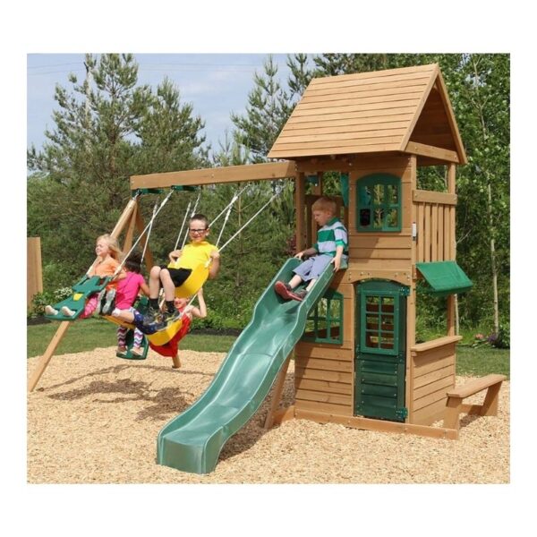 Kidkraft Windale Fort outdoor swing set featuring a wooden fort, swings, and a slide in a backyard setting.