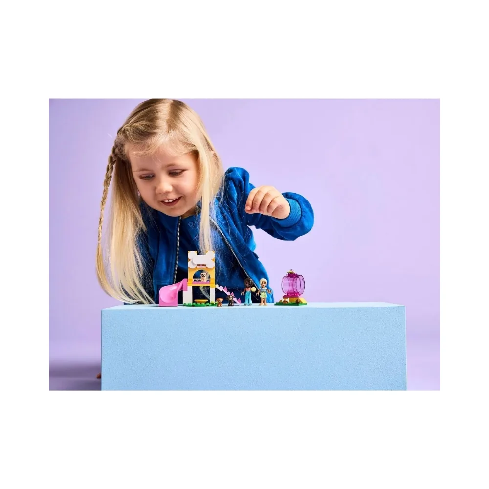 Colorful LEGO set featuring a puppy playground with various play structures and playful dogs