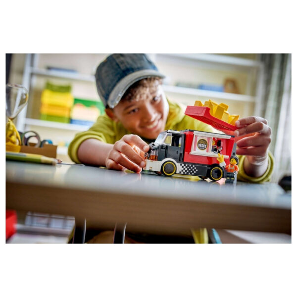 A colorful LEGO food truck set featuring a fries vendor, complete with fries, customers, and outdoor seating