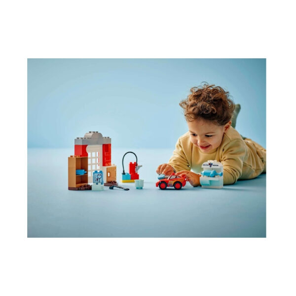 LEGO Duplo set featuring Disney and Pixar's McQueen visiting Doc, with colorful blocks and characters for imaginative play