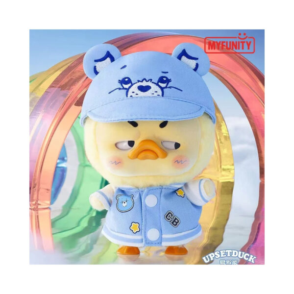 Plush keychain of a rainbow duck from the Care Bears x Upset Duck collaboration, presented in a blindbox packaging