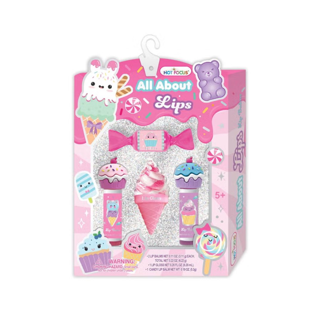 A colorful set of lip glosses labeled "Hot Focus - Sweets," showcasing various shades and flavors in a stylish packaging.
